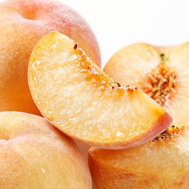 Macro shot of frozen peach slices, rich golden color, subtle frost crystals, sharp commercial focus, clean background