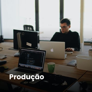 a man sitting at a table with a laptop and a laptop
