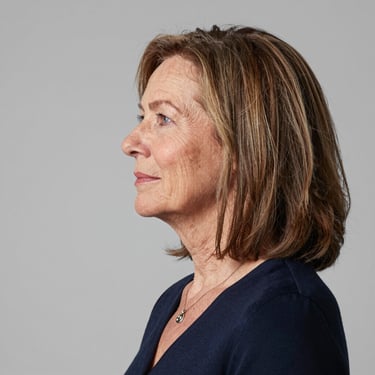 Newly installed stylish garage door with a happy homeowner standing nearby.