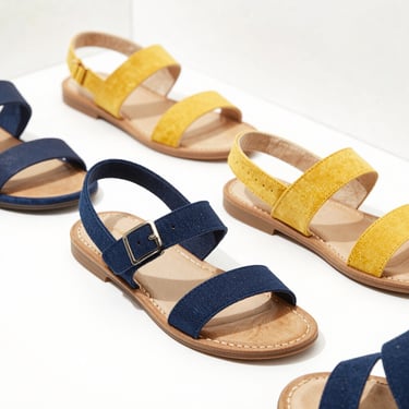 Clean commercial shot of stylish Paragon women's flat sandals, bright natural lighting, soft shadows