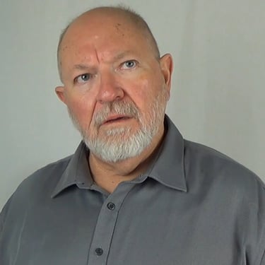 David-Graham Parker wearing a dark grey business shirt with a questioning look on his face