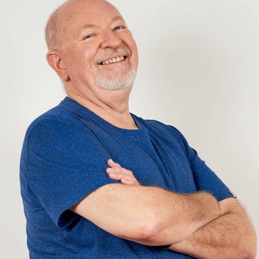 David-Graham Parker smiling broadly wearing a dark blue T Shirt