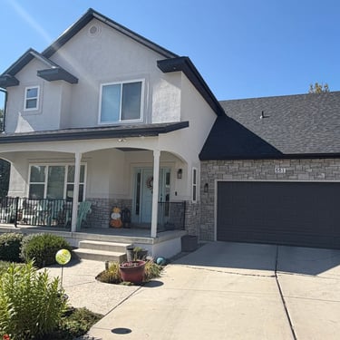 after exterior remodel is now cream-colored stucco with natural stone veneer with light to medium gray tones.