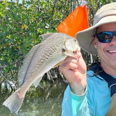 Kayak fishing with a redfish catch