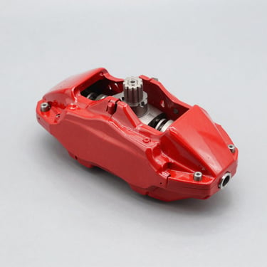 Clean red car brake caliper, bright studio lighting, neutral light gray background, sharp focus