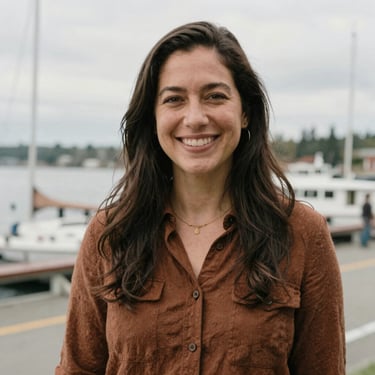 Eye-level portrait of a warm, smiling female educator in Shoreline, soft natural overcast daylight, rich earthy tones.