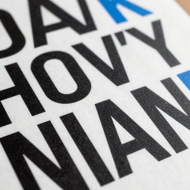 Square detail of a graphic design canvas showing bold grotesque typography and blue accents