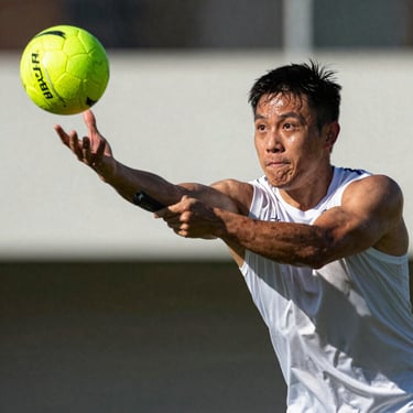A quadball beater aiming a dodgeball mid-throw, sweat-glistening face, intense athletic focus.