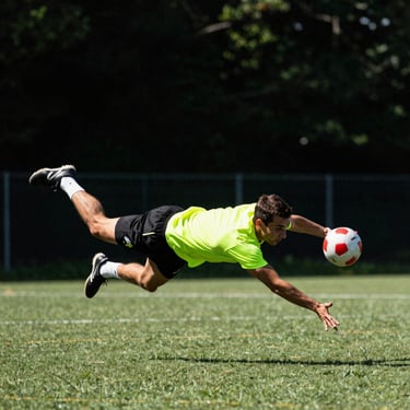 A quick quadball seeker diving to catch the flag runner, dynamic sports photography, film grain.