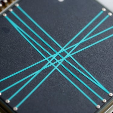 Crisp high-contrast technical diagram showing light paths of six coplanar sensors intersecting on a micro-electronics board, electric cyan lines on dark background.