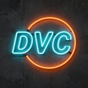 Vibrant custom neon flex sign on a dark concrete wall, glowing intense cyan and orange curves