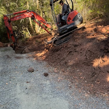 Excavator at angle digging dirt