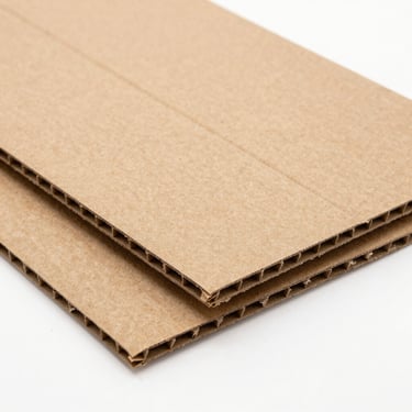 A heavy-duty corrugated cardboard packaging prototype template, showing clean unburned laser-cut edges, flat-lay composition.