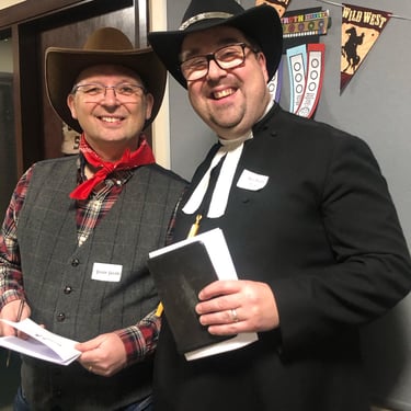 Two men dressed up for a Wild West cowboy murder mystery.