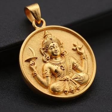 Macro lens view of a detailed gold pendant with traditional Indian motifs, shallow depth of field, premium studio setting.