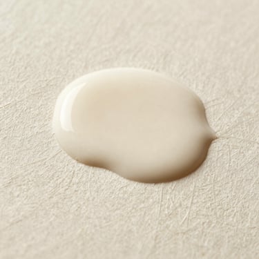 Macro close-up of ink pooling on premium textured cream paper, showing fine lines and organic paper grain under directional light.