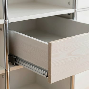 Detail of a modern modular wardrobe drawer with soft-close mechanism in action, crisp focus