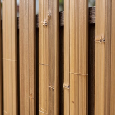 Close-up of premium bamboo fencing with clean vertical lines and dark brown structural frame