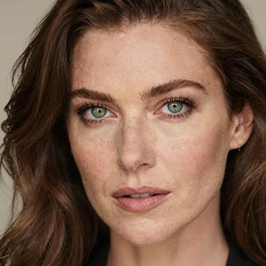 A smiling middle-aged man wearing ankle braces while walking in a park on a sunny day.