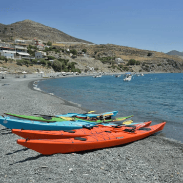 South Crete beach coast with kayaks resting on the beach shore