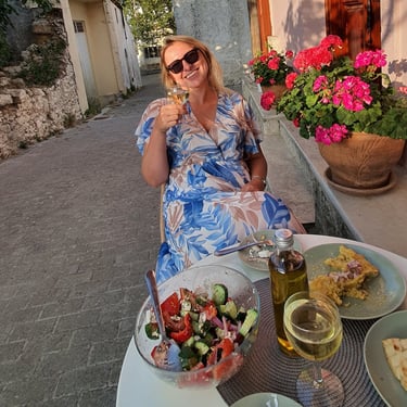Guest enjoying Cretan wine and food outside Tonia’s Cottage
