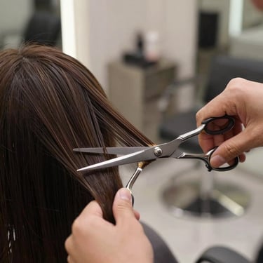 Precise shears cutting clean hair ends in a modern salon setup, soft-focus background, focus on professional technique
