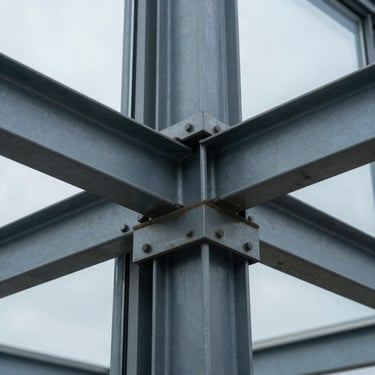 Extreme macro detail of structural steel joints and heavy architectural glass, cool overcast lighting.