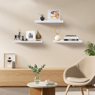 White floating shelves displaying plants, books, and modern home decor accessories