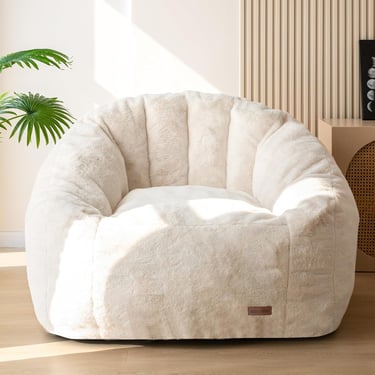Cream plush faux fur bean bag chair in a modern living room setting.