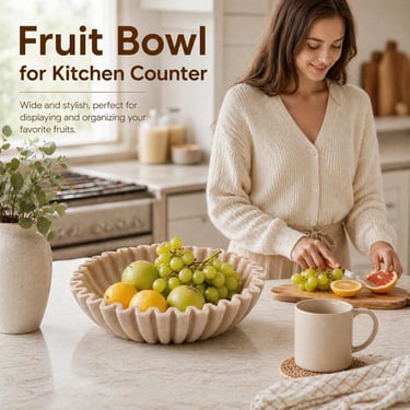 A stylish stone fruit bowl for kitchen counters filled with fresh grapes and citrus fruits.