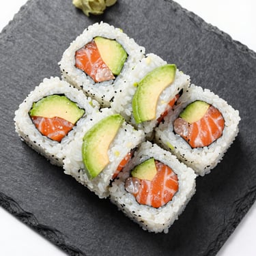 Overhead macro shot of fresh salmon avocado sushi rolls, clean black slate plate, bright natural daylight, sharp focus.