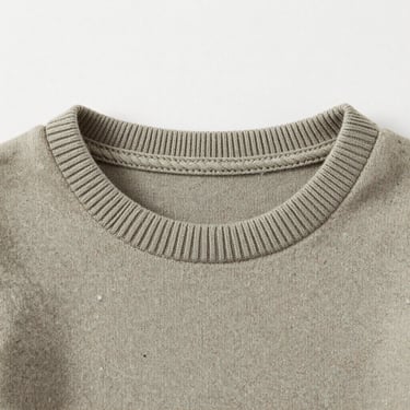 Close-up of a soft organic cotton kid's rib-knit collar with non-toxic dye, flat-lay composition, sharp studio lighting.