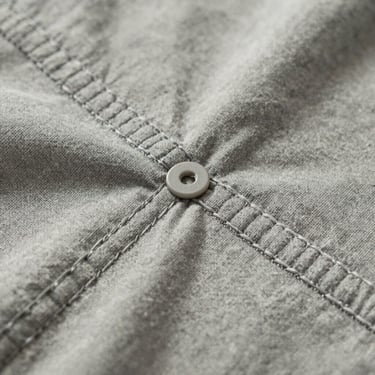 Close-up of flatlock stitching on organic cotton children's wear, showing non-toxic dye saturation