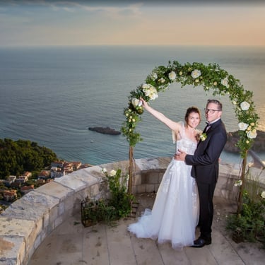 Sunset wedding ceremony Sveti Stefan Perast - Bride groom at flower arch clifftop Adriatic Sea Boka Bay Montenegro