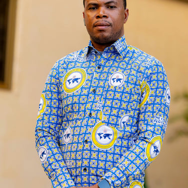 a man in a blue shirt and tan pants