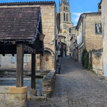 lavatory, cobblestone street and bell tower of saint emilion