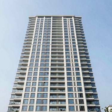 Luxury waterfront apartment tower, wide-angle, Surabaya.
