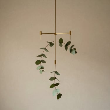 Modern minimal brass and eucalyptus leaf hanging mobile, delicate metallic chains