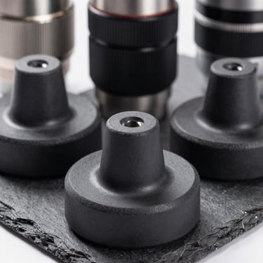 Industrial rubber mounts and vibration dampers, matte black texture, sharp focus