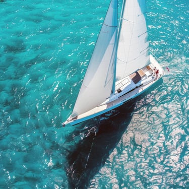 Sailboat cruising over clear turquoise water in the Dominican Republic