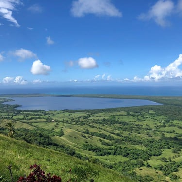 Laguna Redonda panoramic view in Miches Dominican Republic with green hills and blue sky