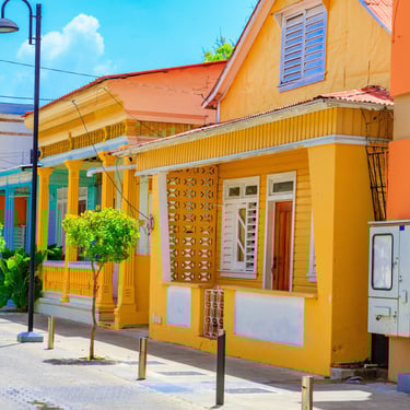 Colorful colonial-style houses on a sunny street in Puerto Plata, Dominican Republic