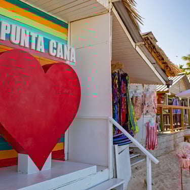 Colorful Punta Cana beach market with "I ❤️ Punta Cana" sign and tropical souvenirs