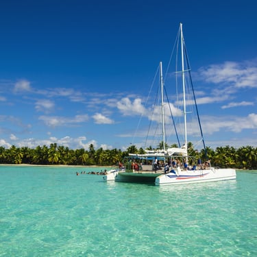 Catamaran tour in clear turquoise water at Saona Island, Dominican Republic