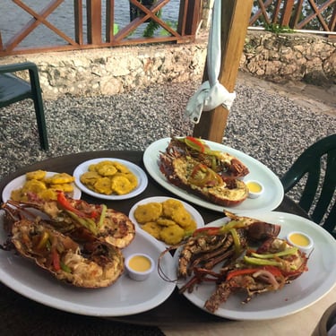 Grilled lobster and tostones at a beachfront restaurant in Boca de Yuma, Dominican Republic