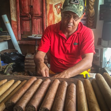Dominican man hand-rolling cigars in a local cigar factory in the Dominican Republic