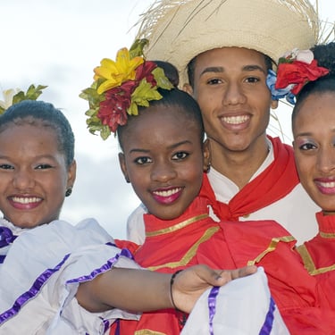 Smiling dancers in traditional Dominican Republic costumes celebrating local culture and heritage