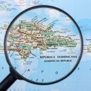 Magnifying glass highlighting map of the Dominican Republic with cities and regions