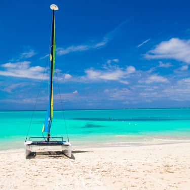 Catamaran on white sand beach with turquoise water in the Dominican Republic