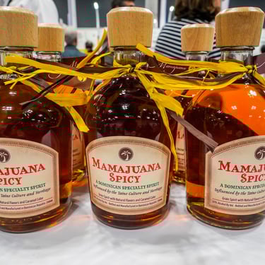Bottles of Dominican Mamajuana Spicy on display at local market or festival